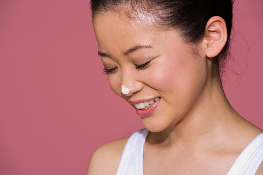 woman with cream on her nose